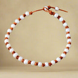 collier ras du cou en cuir perlé