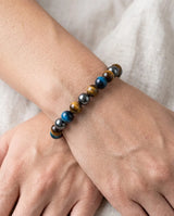 powerful protection bracelet beaded stretch  featuring blue, brown, and gray tiger's eye beads, shown worn on a person's wrist 